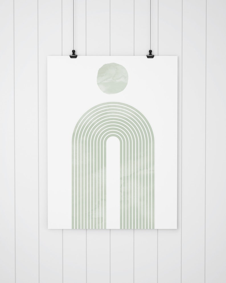 K&ouml;nnte beinhalten: Ein digitaler Druck eines gr&uuml;nen Aquarell-Regenbogenbogens mit einem Kreis dar&uuml;ber. Der Druck h&auml;ngt an einer wei&szlig;en Wand.