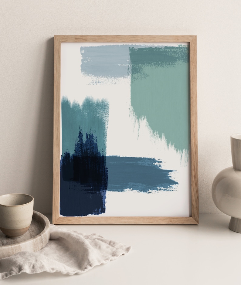 May include: Abstract art print in a wooden frame with blue, green, and white brushstrokes.