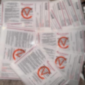 May include: A collection of white and red labeled packages. The labels feature the text "WOCKHARDT" and "PROMETHAZINE CODEINE ORAL SOLUTION" with a large orange "C" logo. The packages are arranged in a slightly overlapping pattern.