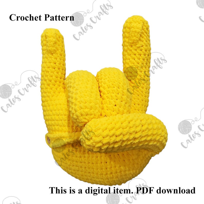 Pu&ograve; includere: Uno schema all'uncinetto per una mano gialla che fa il gesto rock and roll. Lo schema &egrave; un download digitale.