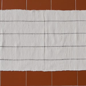 Cream with black line and tassels, handwoven Portuguese Puxados (boho) rag rug suitable for bathroom, kitchen, bedroom or nursery.
