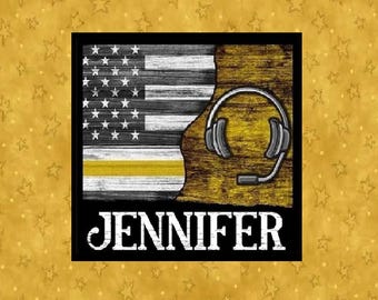 May include: A square image with a black border features a stylized American flag in black, white, and yellow, with a headset graphic. The name "JENNIFER" is displayed in bold white letters below the flag and headset design.