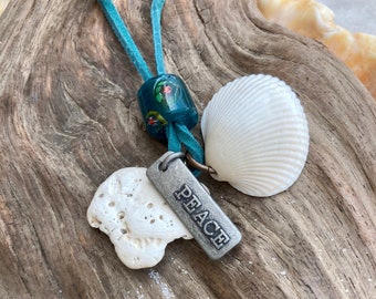 Seashell amulet necklace on adjustable suede cord