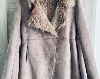 May include: A dusty rose faux suede coat featuring a wide faux fur collar and matching faux fur trim along the front opening, cuffs, and hem. The interior is lined with soft faux fur, and the inner label displays the text DENIM CO.