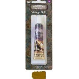 May include: A tube of "Vintage Gold" metallic wax by Art Alchemy, 20 ml. The product is packaged in a clear plastic container with a dark brown label. The packaging has a weathered, textured appearance, with a swatch of the gold wax at the bottom.
