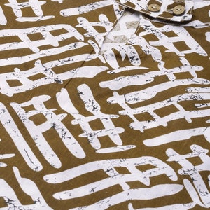 May include: A brown and white patterned fabric with a geometric design. The fabric has a textured surface and a slightly distressed look.