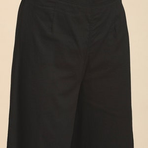 May include: Black wide-leg pants with a flat front and a zipper fly.