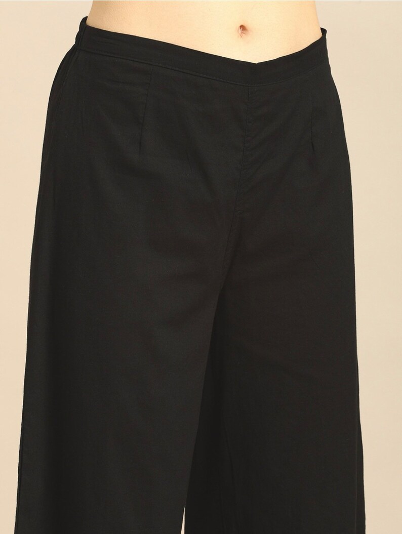 May include: Black wide-leg pants with a flat front and a zipper fly.
