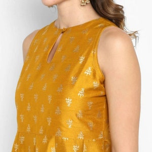 May include: A mustard yellow sleeveless dress with a small keyhole neckline and a gold floral print.