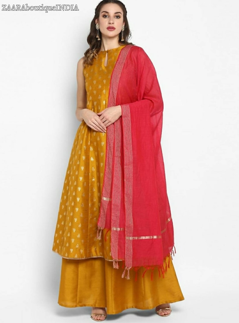 May include: A mustard yellow sleeveless kurta with a gold print and a matching palazzo pant. The kurta has a keyhole neckline and a pink dupatta with gold trim.