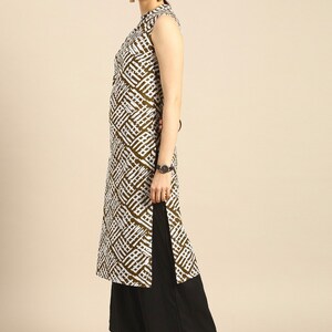 May include: A sleeveless white and brown patterned kurta with a mandarin collar and a side slit. The kurta is paired with black palazzo pants.