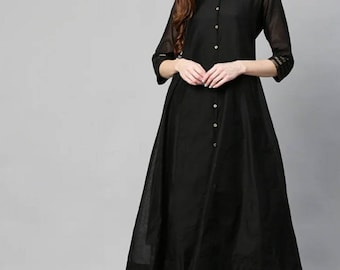 May include: A black long-sleeved kurta with a button-up front and gold trim on the sleeves. The kurta is paired with black palazzo pants with a gold print.