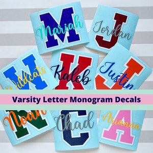 May include: Assortment of colorful varsity letter monogram decals on a light blue background. The decals feature the letters M, J, K, J, W, N, C, and A, with names written in cursive above each letter. The text "Varsity Letter Monogram Decals" is displayed in a pink banner.