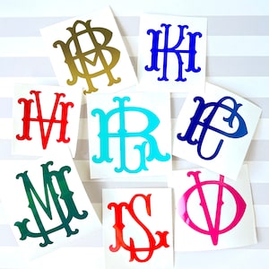 May include: Nine monogram stickers with different letters and colors. The letters are in a traditional script font. The colors are gold, blue, red, turquoise, green, and pink.