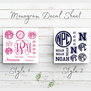 May include: Two sheets of monogram decals. The first sheet features the letters "APM" in pink with the name "Arianna" written below. The second sheet features the letters "NPC" in navy blue with the name "Noah" written below.