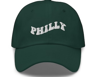 May include: A dark green baseball cap with white embroidered text that reads "PHILLY" in a retro font.