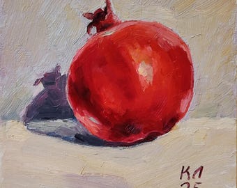 May include: Oil painting of a ripe pomegranate. The fruit is a vibrant red with highlights, casting a dark purple shadow. The background is a neutral beige, and the artist's signature and the number 25 are visible.