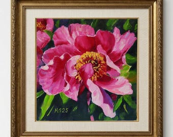 May include: A framed painting of a vibrant pink peony flower with a yellow centre. The artwork is set against a dark green background with visible brushstrokes. The painting is in a gold-coloured ornate frame, with the artist's signature "K125" visible.