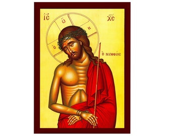 Puede incluir: Un icono religioso que representa a Jesucristo, conocido como el "Esposo", con una corona de espinas, una túnica roja y un bastón. El icono está pintado en un estilo bizantino tradicional con detalles dorados y el texto griego "Ο ΝΥΜΦΙΟΣ" (El Esposo).