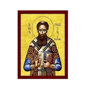 Op de afbeelding: Een icoon van Sint Gregorius Palamas, een Byzantijnse orthodoxe heilige. Het icoon is geschilderd in een traditionele stijl met gouden en rode accenten. De heilige is afgebeeld met een baard en draagt een bisschopskleed. De tekst op het icoon luidt "Ο ΓΡΗΓΟΡΙΟΣ Ο ΠΑΛΑΜΑΣ".
