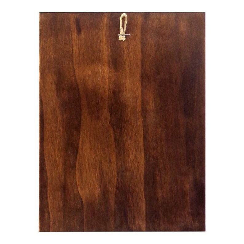 May include: A dark brown wooden plaque with a small loop of twine attached to the top.