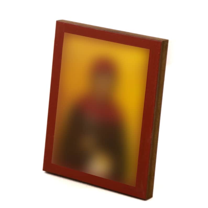 May include: A framed icon with a blurred image of a person in a red and yellow robe. The frame is made of wood with a red border.