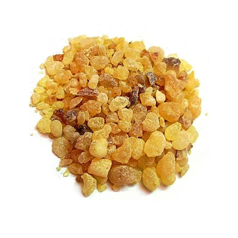 May include: A close-up of a pile of golden brown resin pieces. The resin is irregularly shaped and has a slightly translucent appearance.