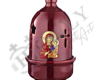 May include: A red ceramic oil lamp with a cross and a star design. The lamp features a depiction of the Virgin Mary holding baby Jesus.