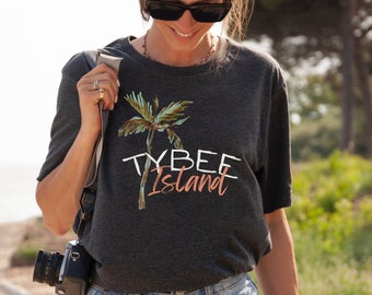 May include: A dark gray t-shirt with a palm tree graphic and the text "Tybee Island" in white and peach.