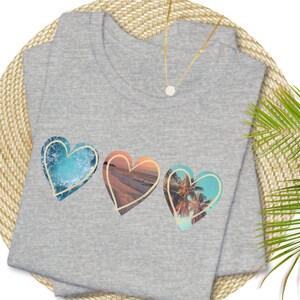 Athletic heather gray tshirt with 3 hearts with ocean scenes in each heart.