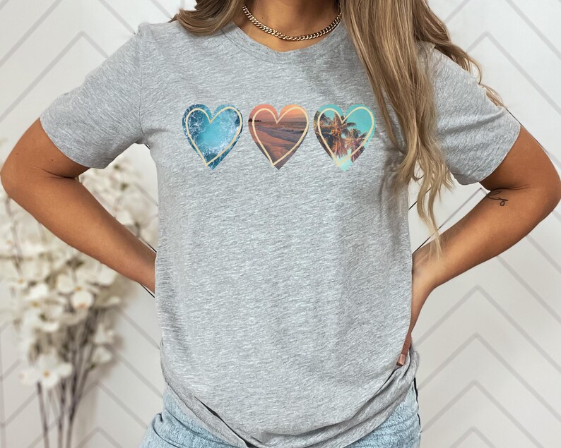 Ocean shirt that has 3 hearts filled with different ocean photos.