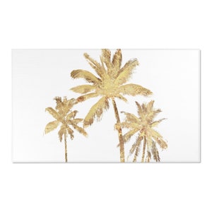 Three gold colored palm trees on a white background area rug. The palm trees are stylized and have a distressed look.