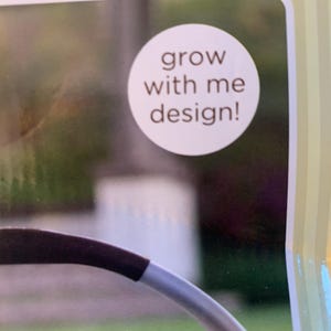 May include: A white circle with the text 'grow with me design!' in brown text.