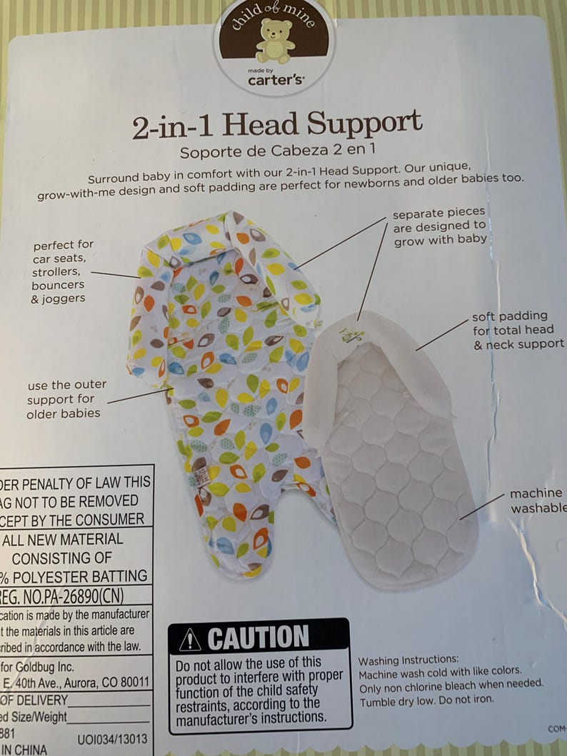 May include: A white and green 2-in-1 head support for babies. The head support is made of soft padding and has a grow-with-me design. The product is machine washable and is designed for use in car seats, strollers, bouncers, and joggers. The product is made by Carter's and is labeled 'child of mine.' The packaging also includes a warning label that reads 'Caution: Do not allow the use of this product to interfere with proper function of the child safety restraints, according to the manufacturer's instructions.'
