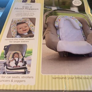 May include: A box for a Carter's Child of Mine 2-in-1 Head Support. The box is yellow and white with a picture of a baby in a car seat and a stroller. The text on the box reads '2-in-1 Head Support', 'comfy head & neck support adjusts to fit your growing baby', 'remove the inner support for larger babies', 'for car seats, strollers, bouncers & joggers', 'surround your little one in comfort', 'grow with me design!'.