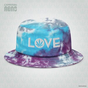 May include: A blue, purple, and white tie-dye bucket hat with the word "LOVE" embroidered on the front. The "O" in LOVE is replaced with a marijuana leaf.