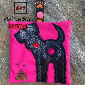 May include: A pink fabric pouch with a black dog embroidered on it. The dog is facing the left side of the pouch and has a brown poop emoji embroidered below it. The pouch has a black and orange strap with a pink button. The text "PlushFish Studio DIGITAL 5x7" is embroidered on the pouch.