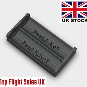 May include: A black plastic storage case with two compartments. The case is engraved with the text "Paul E. Key" on both sides.