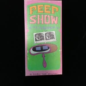 May include: A vintage "Peep Show Cards" box with a pink and green design. The box features the words "PEEP SHOW" in orange and a graphic of a viewer with two images. The bottom of the box reads "16 DOUBLE TAKE MESSAGES."
