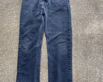 Black Levi’s 505 30x28(tag says 32x30) denim jeans. Incredibly soft. Faded. Distressed. Some holes.   Ankle 7.5 Knee 8.5  Thigh 10.5