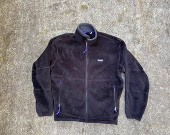 Vintage Patagonia medium large black Polartec Regulator full zip jacket. Cut 2175 style 25130. 2 zipper hand pockets. Made in the USA.