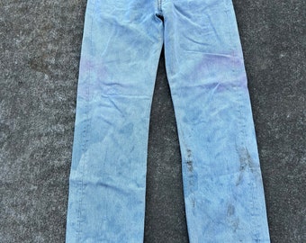 Vintage 90s Levi’s  501 button fly 29x29(tag 31x30)100% cotton denim jeans. Made in the USA 10/1997. Crazy bleach mark color scheme. Red