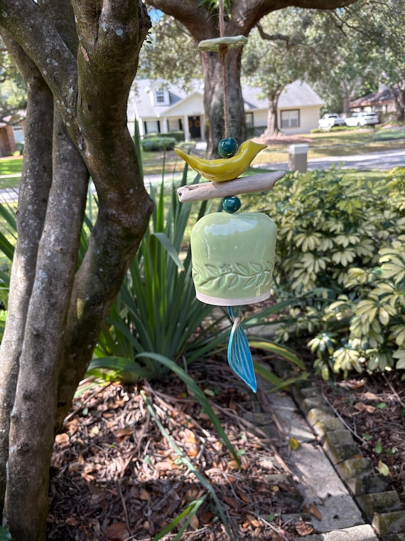 Whimsical Handcrafted Wind Bell with yellow bird perched atop natural driftwood,