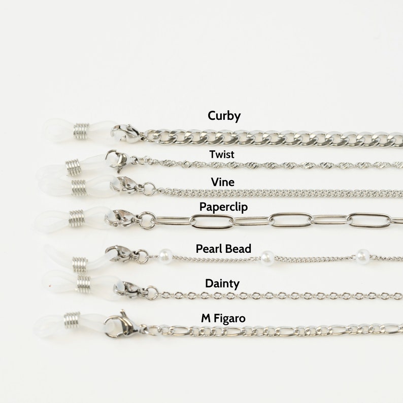 May include: A collection of silver-toned eyeglass chains with various designs, including Curb, Twist, Vine, Paperclip, Pearl Bead, Dainty, and M Figaro styles. Each chain features clear rubber loops for attaching to glasses and a clasp closure.