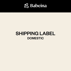 May include: A white shipping label with black text that reads "SHIPPING LABEL DOMESTIC".