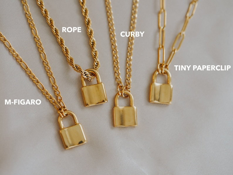 May include: Five gold necklaces with padlock pendants. The necklaces are on a white background. The necklaces are labeled: M-Figaro, Rope, Curby, Tiny Paperclip.