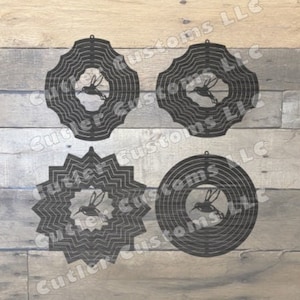 May include: Four black metal hummingbird wind spinners with a decorative design. The wind spinners are on a wooden background.