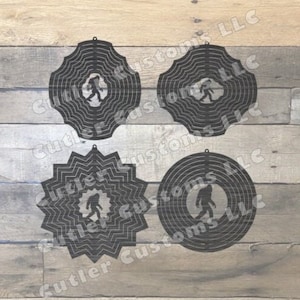 May include: Four black metal wind spinners featuring a Bigfoot silhouette. Each spinner has a different design, including wavy and zigzag patterns. The text "Cutler Customs LLC" is visible in the background.