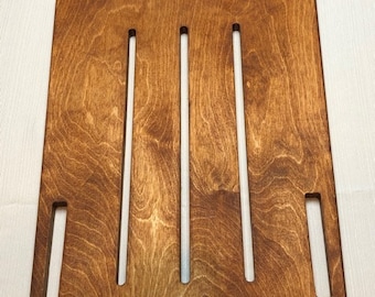 May include: A wooden tray with five slots, stained in a rich brown color. The tray has a simple design with rounded edges and is perfect for organizing small items.