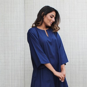 Model is wearing full sleeves blue color dress, Dress has split neck. This is knee length sexy dress. Wear this dress for any occasion. Simple, comfortable, Loungewear dress. Select any color and customize your dress of your choice